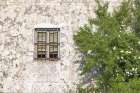 Montefrio, Granada, Andalusia, Spain. A barred window on an old stucco building. Art Print